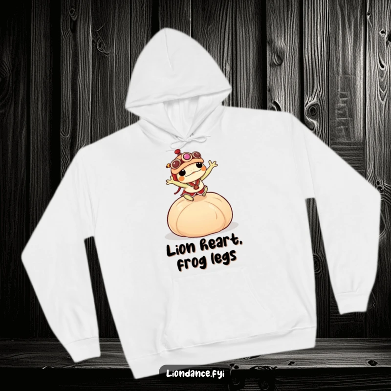 Funny frog in a miniature lion dance costume jumping over a large dumpling, depicted on a soft, warm hoodie.