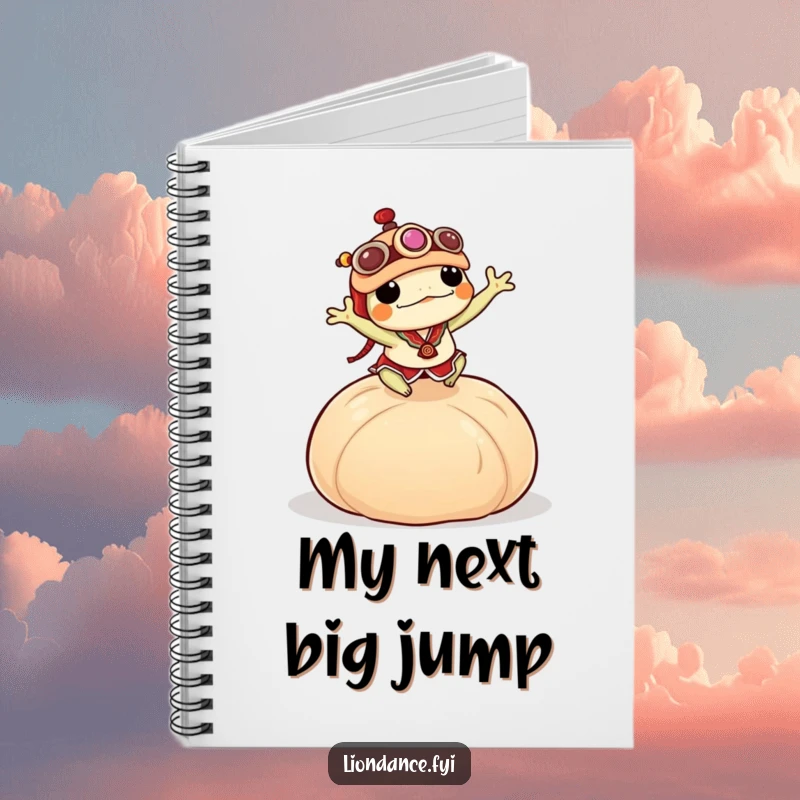 Funny frog in a lion dance costume energetically leaping over a large dumpling, shown on the cover of a notebook.